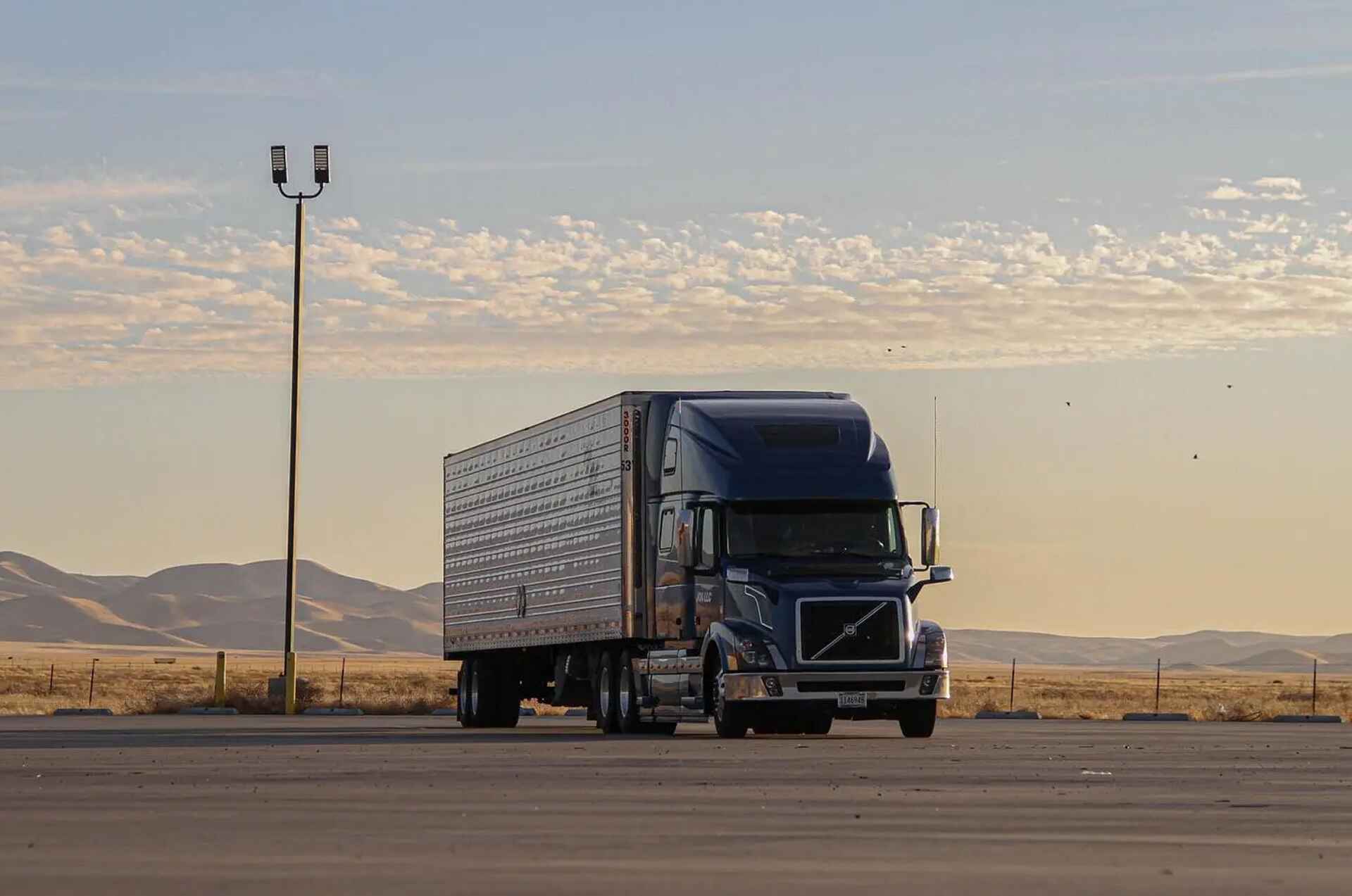 semi truck parked in a parking lot in a desert area