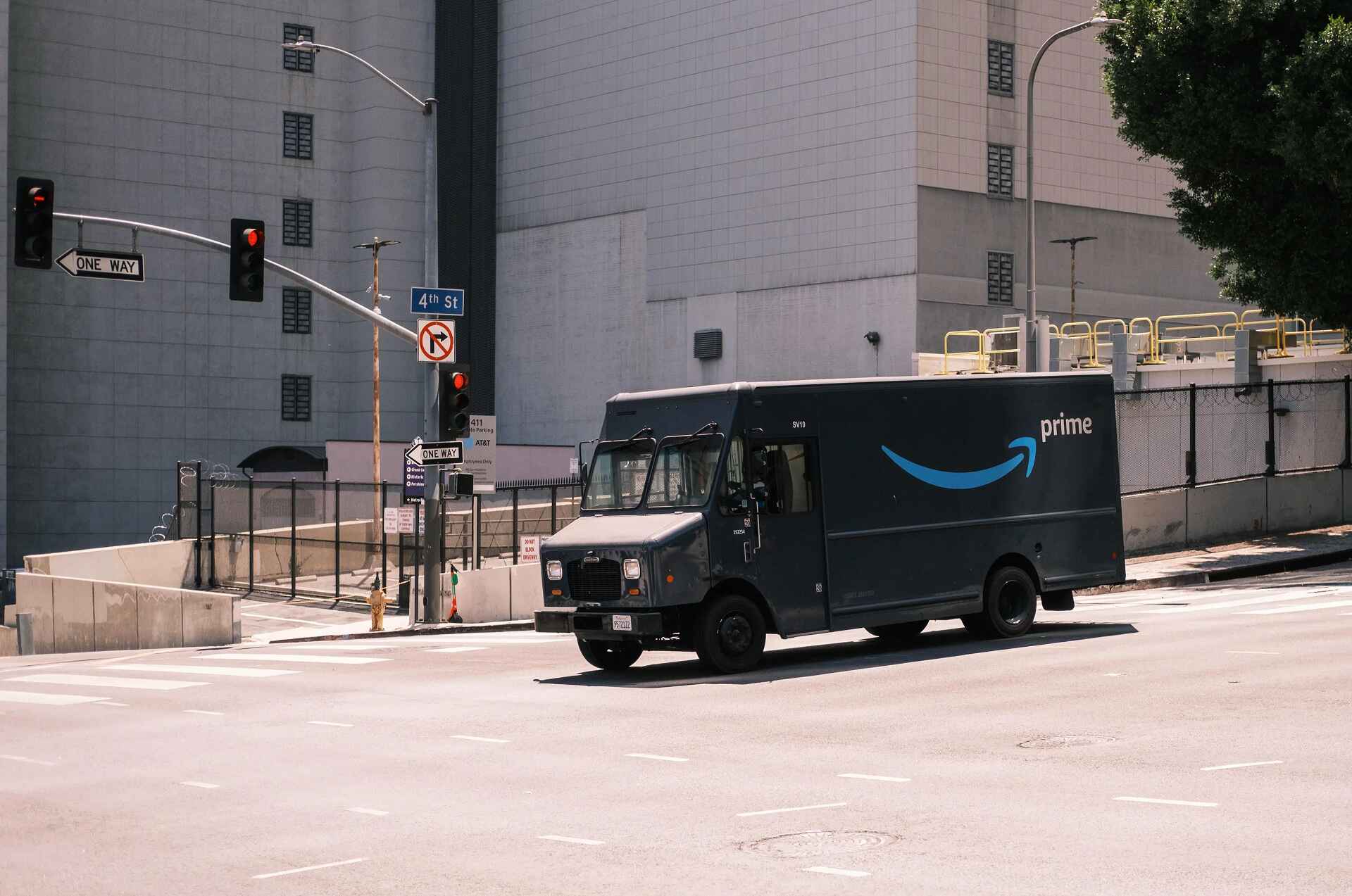 Amazon prime truck driving through an intersection in an industrial area